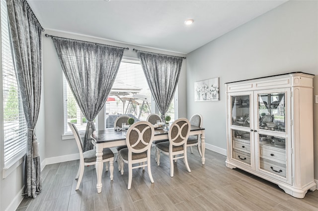 dining area featuring plenty of natural light and light hardwood / wood-style floors