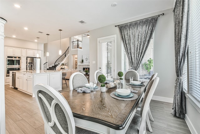 dining room with light hardwood / wood-style floors and sink