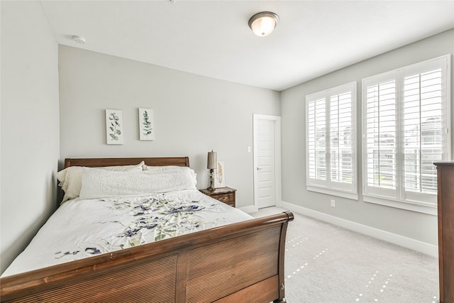 bedroom featuring multiple windows and carpet