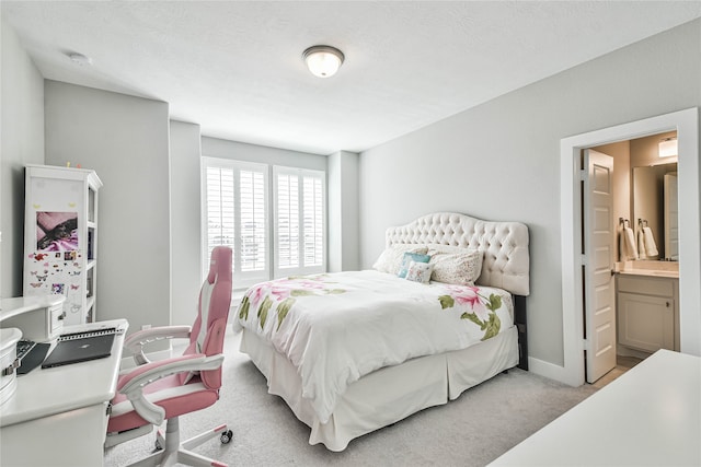 carpeted bedroom featuring connected bathroom