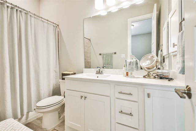 bathroom with tile floors, toilet, and vanity