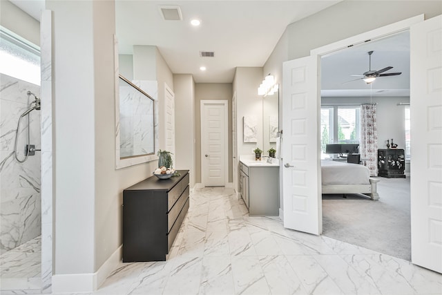 bathroom featuring vanity, tile floors, ceiling fan, and tiled shower