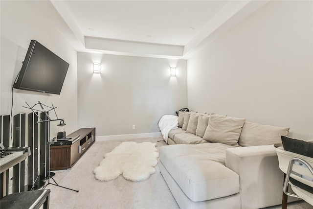 carpeted living room featuring a tray ceiling