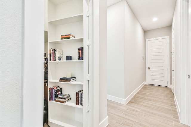 hall with light hardwood / wood-style floors