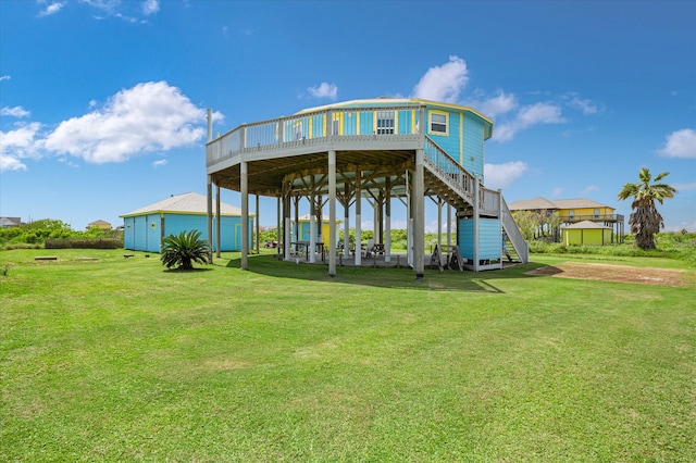 back of property with a lawn and a deck