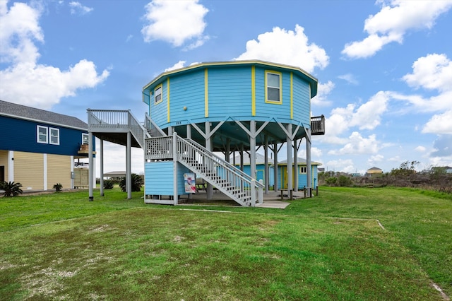 back of house with a wooden deck and a yard