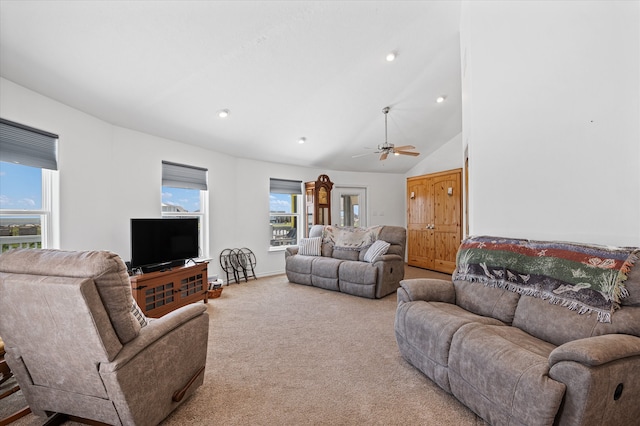 carpeted living room featuring high vaulted ceiling, ceiling fan, and a healthy amount of sunlight