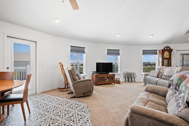 living room featuring light carpet and ceiling fan