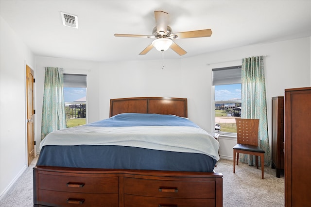 bedroom with ceiling fan and light carpet