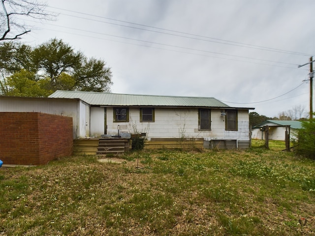 rear view of house with a yard