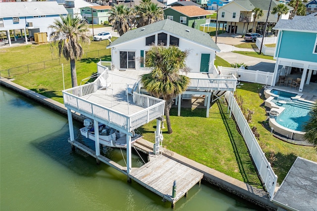 view of dock with a fenced in pool, a yard, a water view, and a patio area