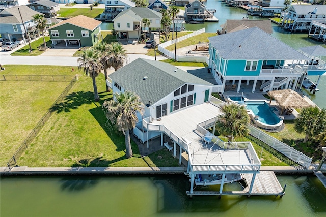 drone / aerial view with a residential view and a water view