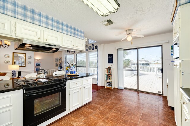 kitchen with black range with electric stovetop, white cabinets, a textured ceiling, and ceiling fan