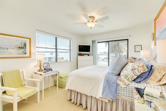 bedroom with access to outside, light carpet, and ceiling fan