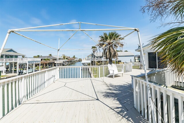 wooden terrace featuring a water view