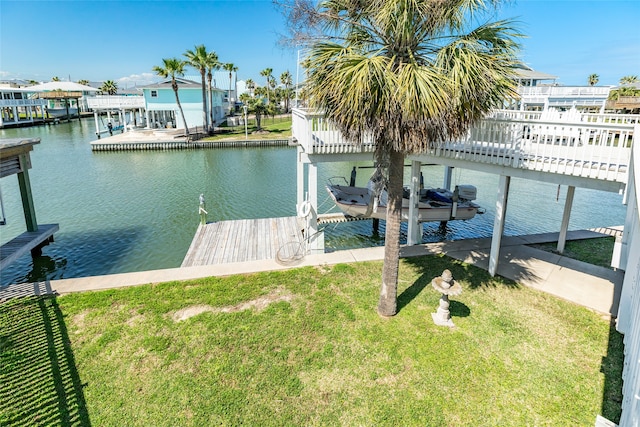 dock area with a water view and a yard