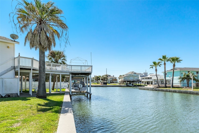 view of dock with a water view and a yard