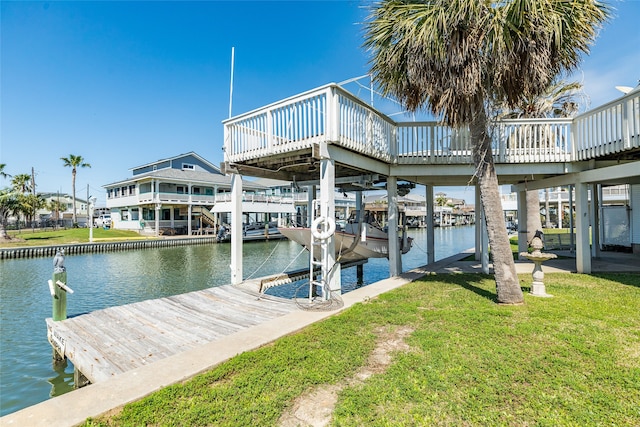 dock area featuring a water view and a yard