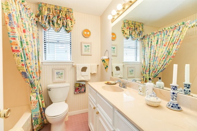 full bathroom with plenty of natural light, vanity, shower / bath combo with shower curtain, and toilet