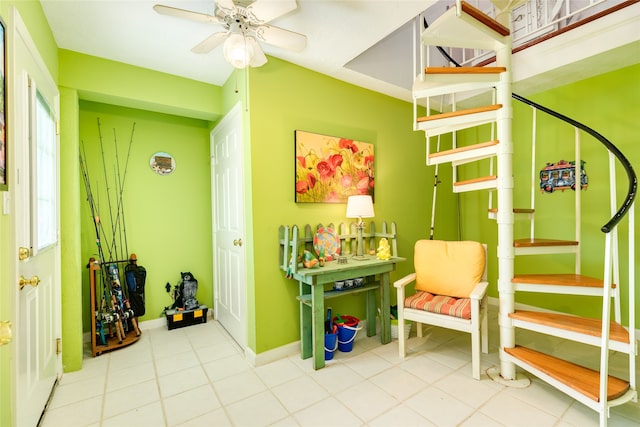 playroom featuring ceiling fan and tile patterned flooring