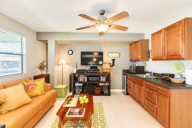 living room featuring ceiling fan and sink