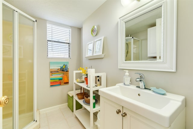 bathroom with vanity and a shower with shower door