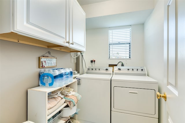 laundry area featuring cabinets and washer and clothes dryer