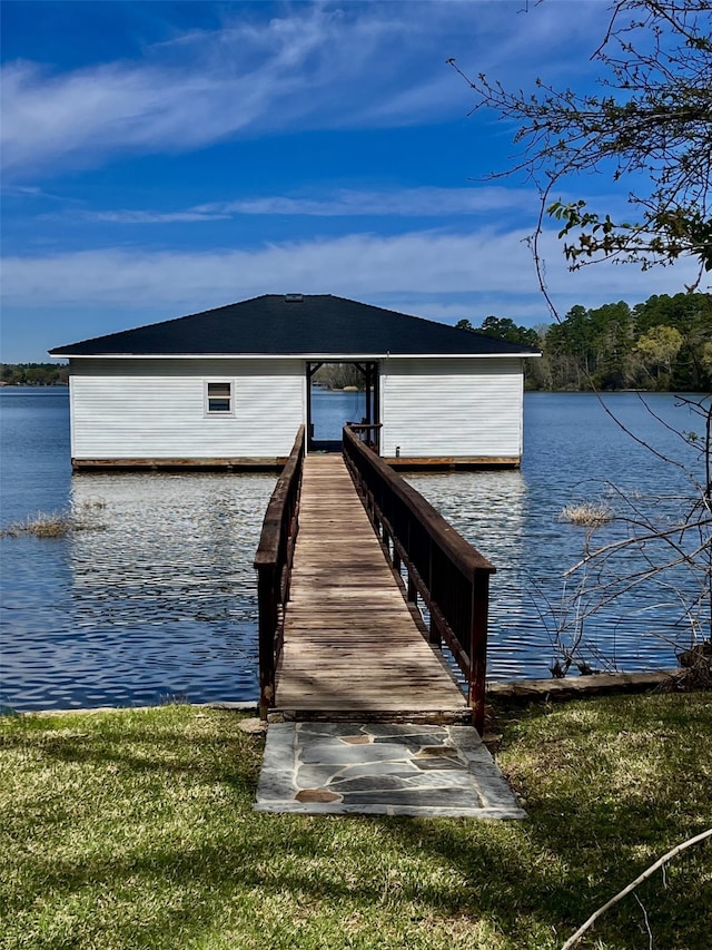 view of dock featuring a water view and a lawn