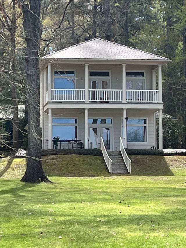 view of front of property with a balcony and a front yard