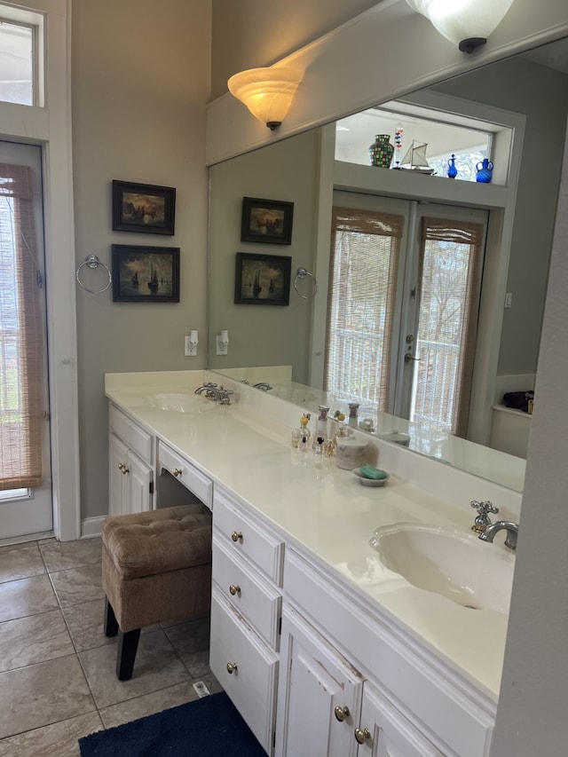 bathroom featuring tile flooring, a wealth of natural light, and dual vanity