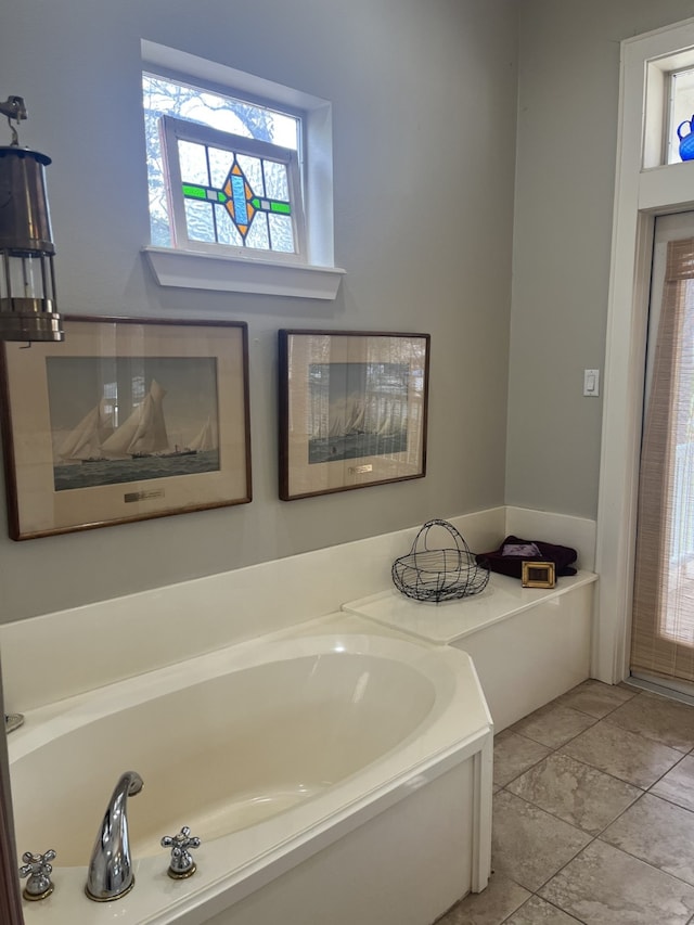 bathroom featuring a bathtub and tile flooring