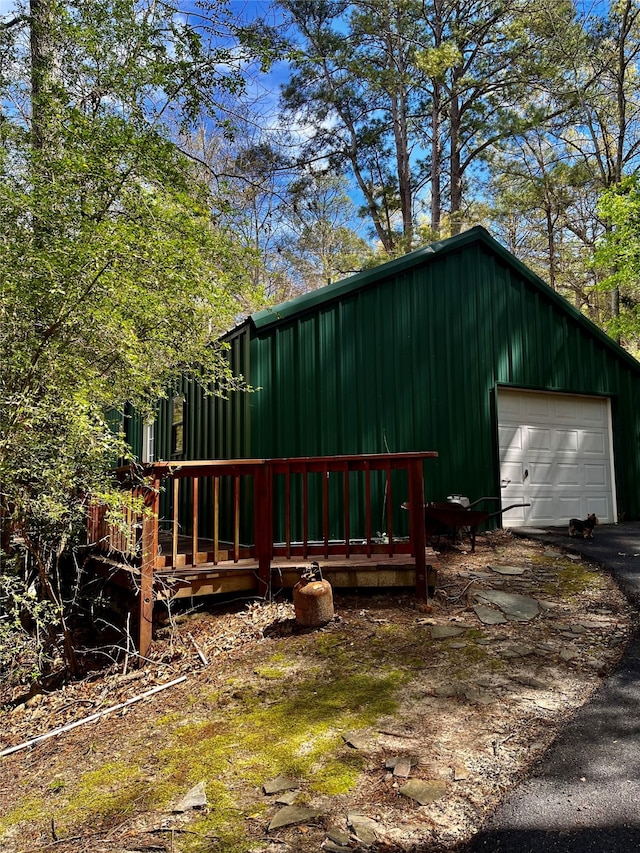 exterior space with a wooden deck and a garage