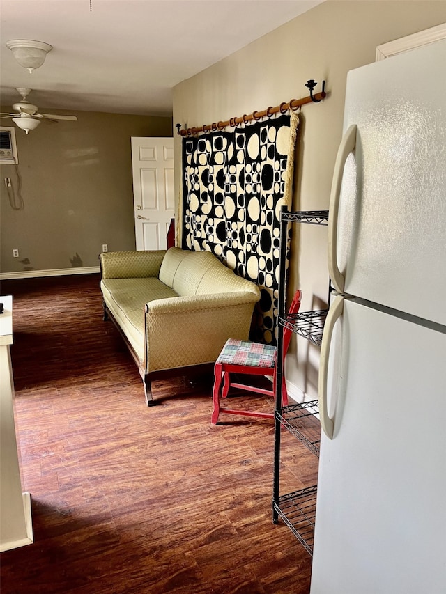 living room with hardwood / wood-style floors and ceiling fan