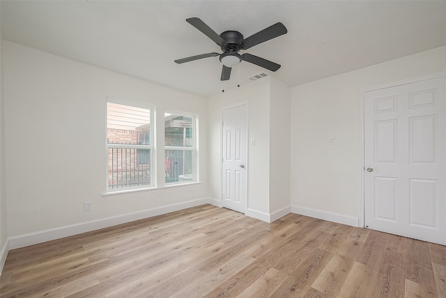 spare room featuring ceiling fan and light wood-type flooring