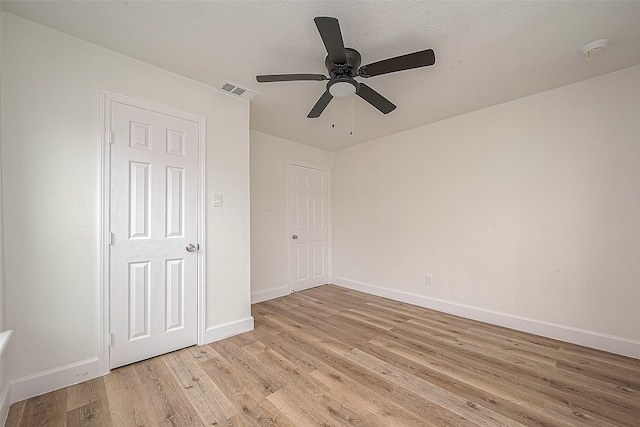 unfurnished bedroom with ceiling fan and light wood-type flooring