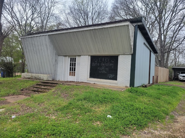 view of outdoor structure featuring a lawn