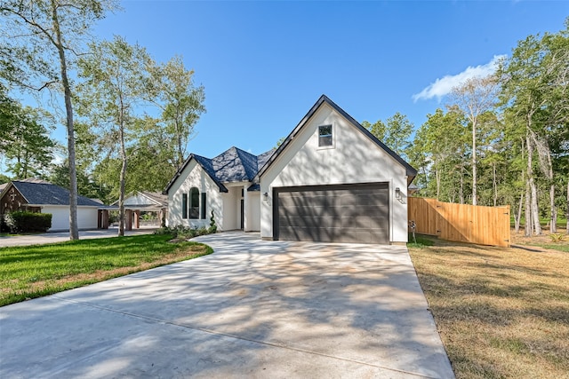 view of front of house featuring a front lawn and a garage