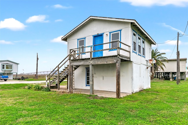 rear view of property featuring a lawn