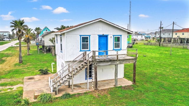 rear view of property with a yard