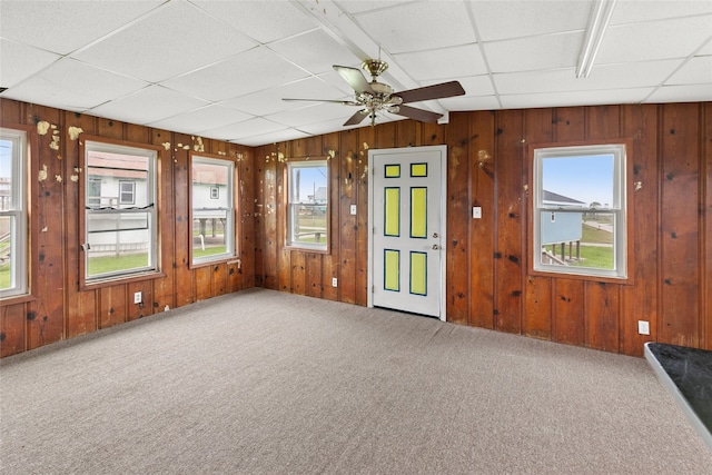 unfurnished sunroom featuring a paneled ceiling and ceiling fan