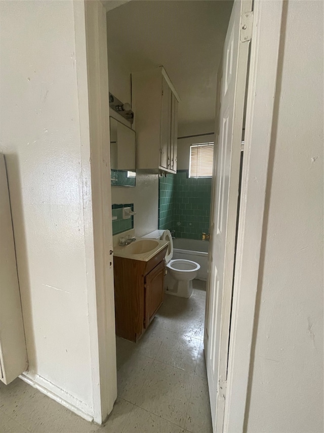 hallway with sink and light tile floors