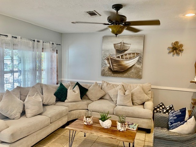 tiled living room featuring ceiling fan