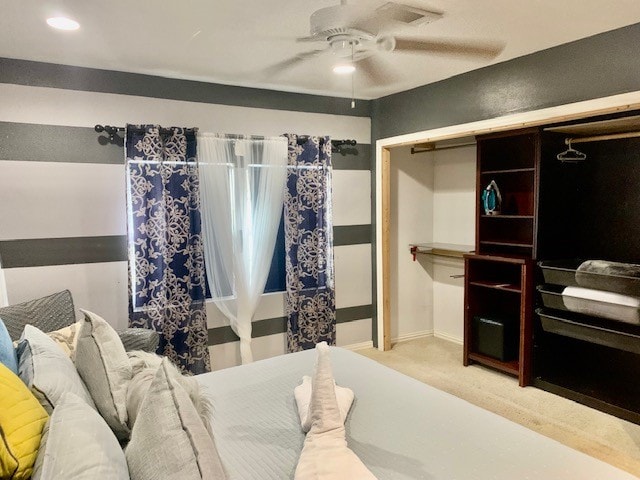 carpeted bedroom with a closet and ceiling fan