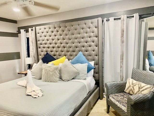 bedroom featuring light carpet and ceiling fan