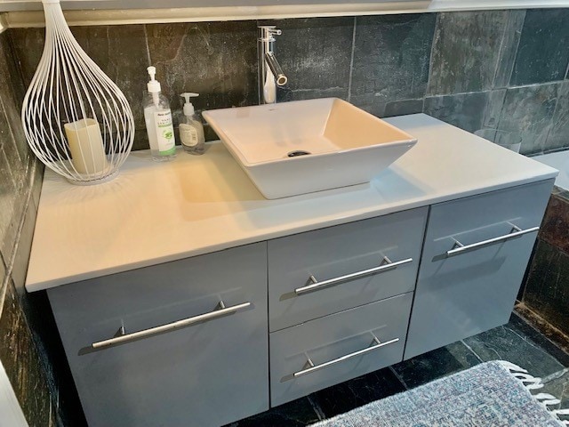 bathroom with tile walls, tile flooring, and vanity