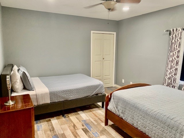 bedroom with a closet, ceiling fan, and light hardwood / wood-style flooring