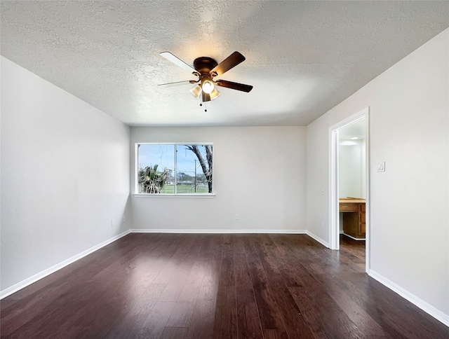 empty room featuring a textured ceiling, ceiling fan, and dark hardwood / wood-style flooring