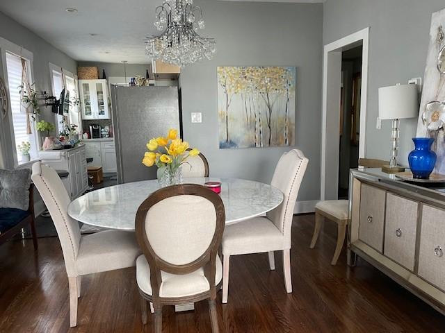 dining area featuring a chandelier and dark hardwood / wood-style flooring