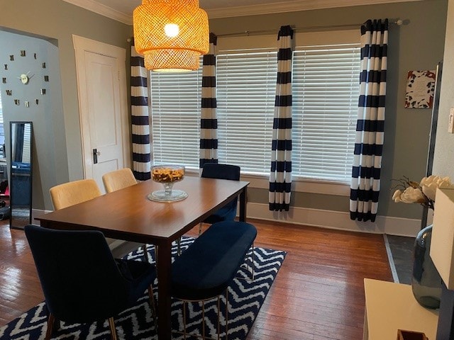 dining area featuring wood-type flooring and ornamental molding