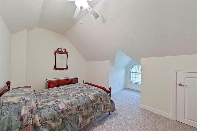 bedroom featuring light colored carpet, vaulted ceiling, ceiling fan, and a textured ceiling